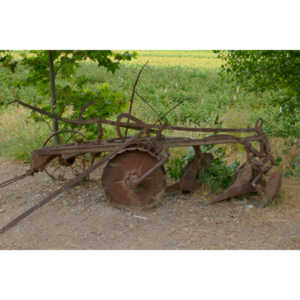 A rusting old farm vehicle.